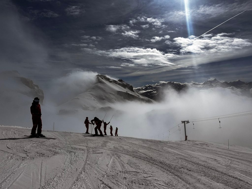 Plaine Morte en Crans-Montana con esquiadores y vistas de los Alpes suizos
